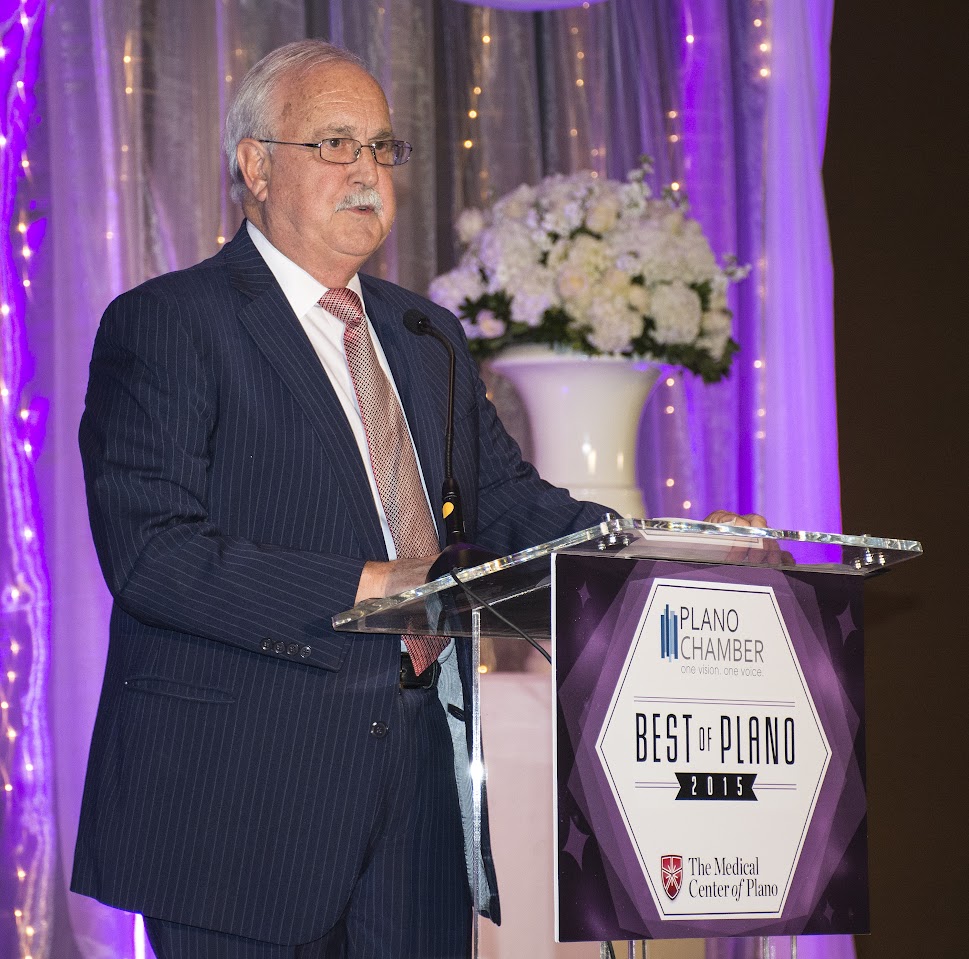 Olin Jaye speaking at a podium